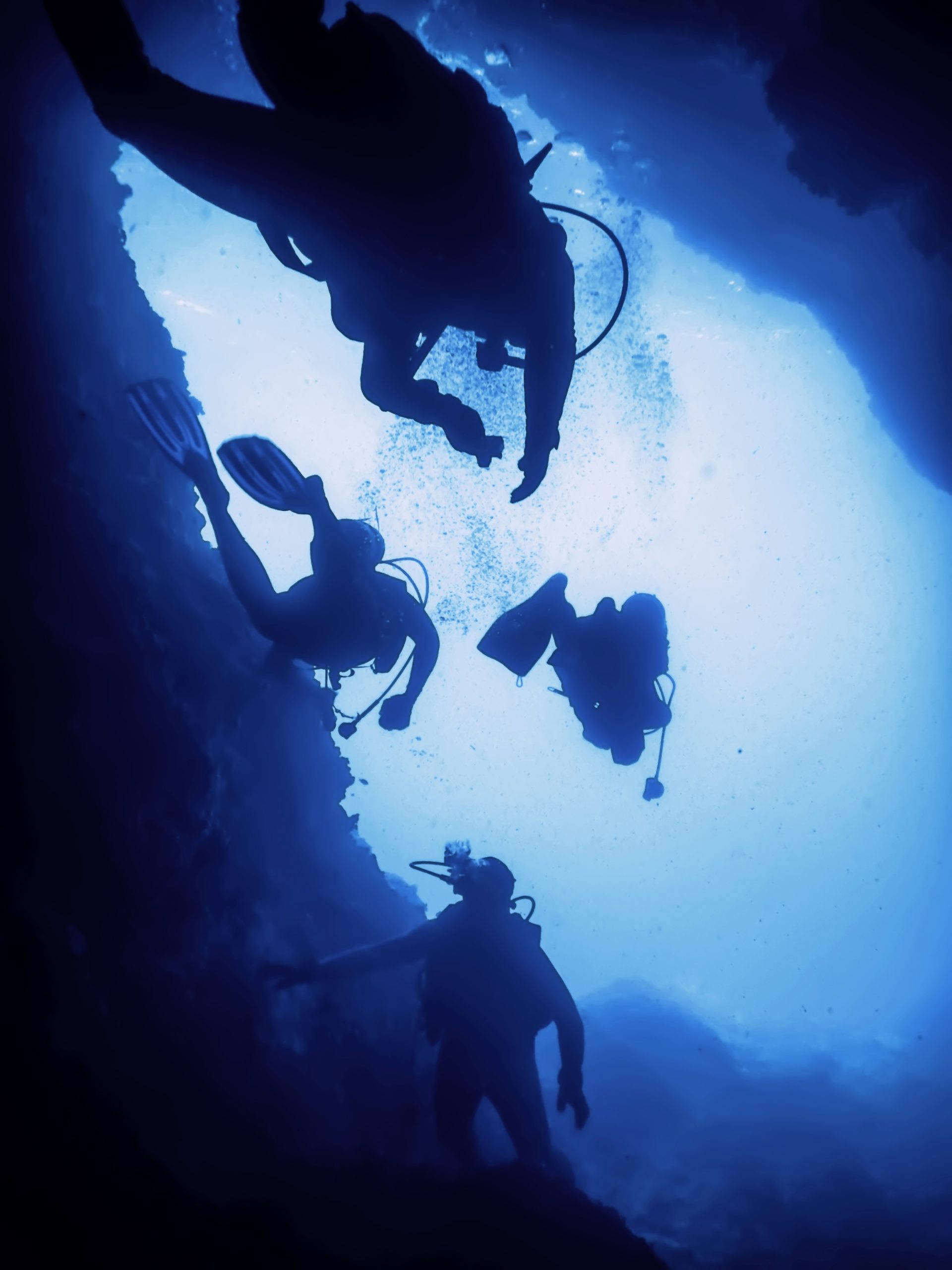 Scuba Divers Silhouette in Underwater Cave